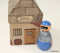 Hand Painted wooden figure of robber and decorated jail house 