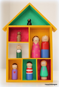 wooden house with hand painted wooden family figures
